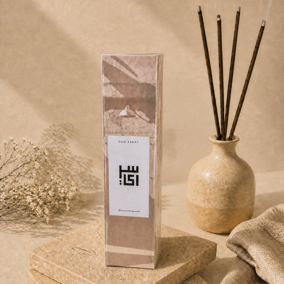Oud Medeem incense sticks box with burning oud sticks in a vase